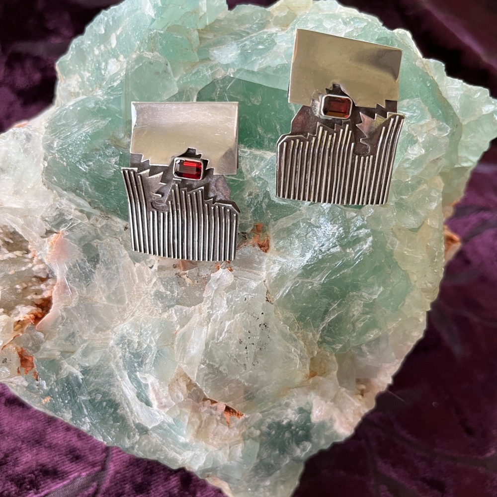 Sterling Silver pierced earrings with garnets.